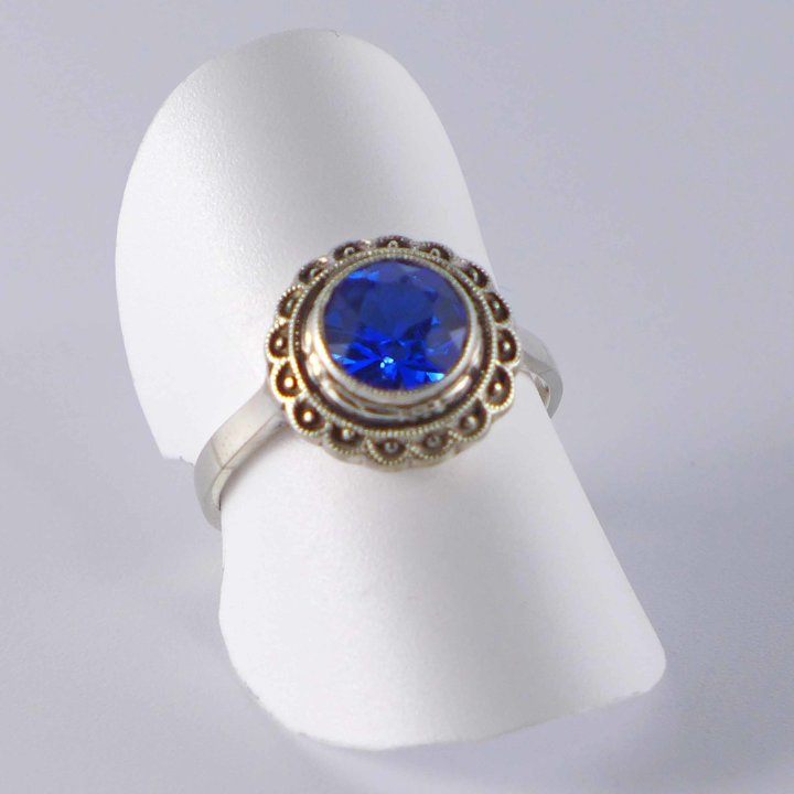 Round silver ring with bright blue crystal glass
