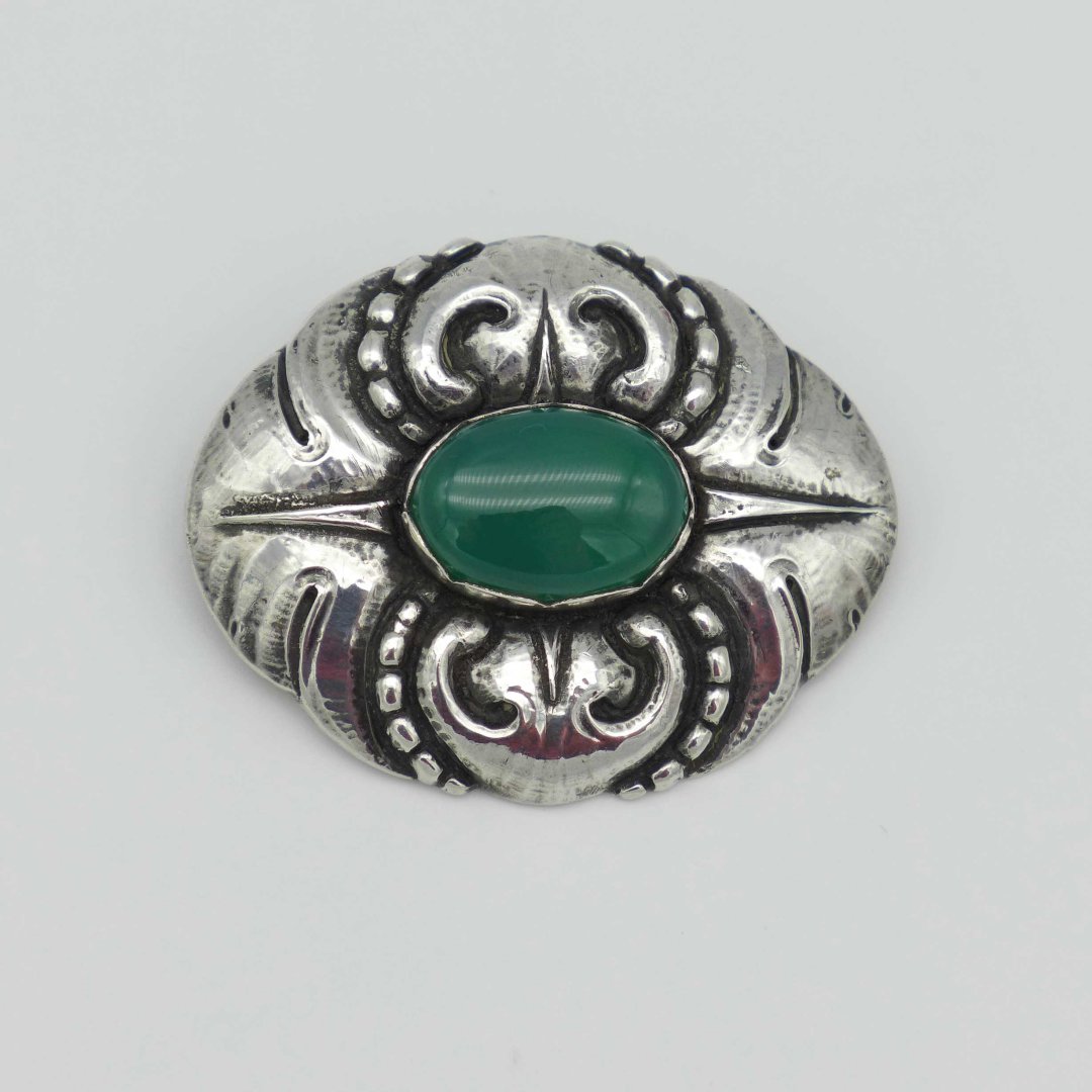 Silver brooch with green agate in Skønvirke style
