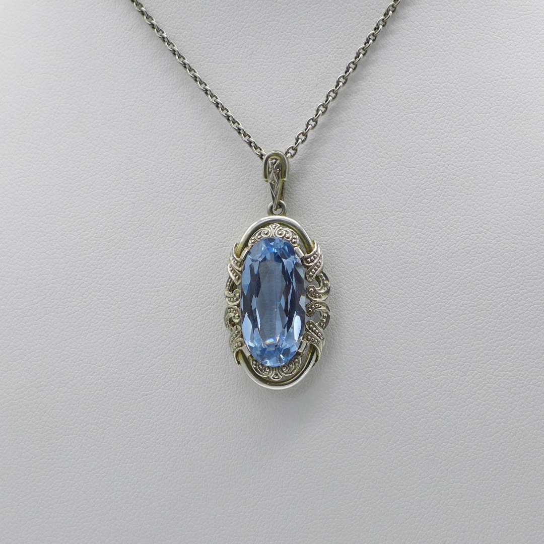 Oval Art Deco pendant with light blue stone