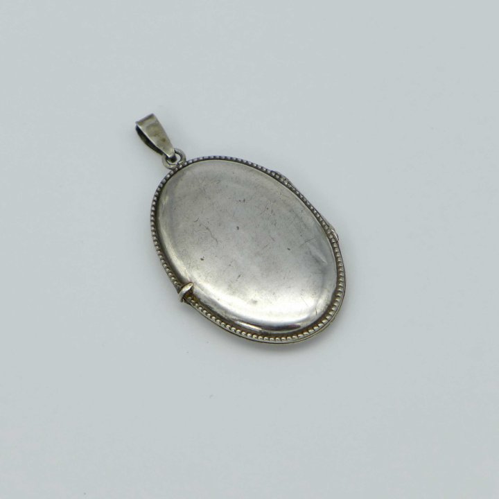 Oval Silver Medallion with Flower Vase