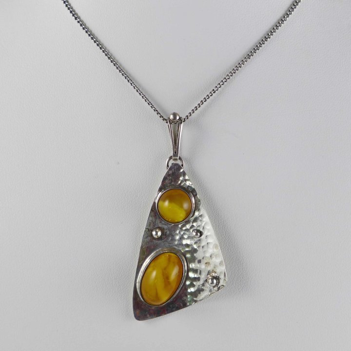 Kidney-shaped amber pendant from the 1950s