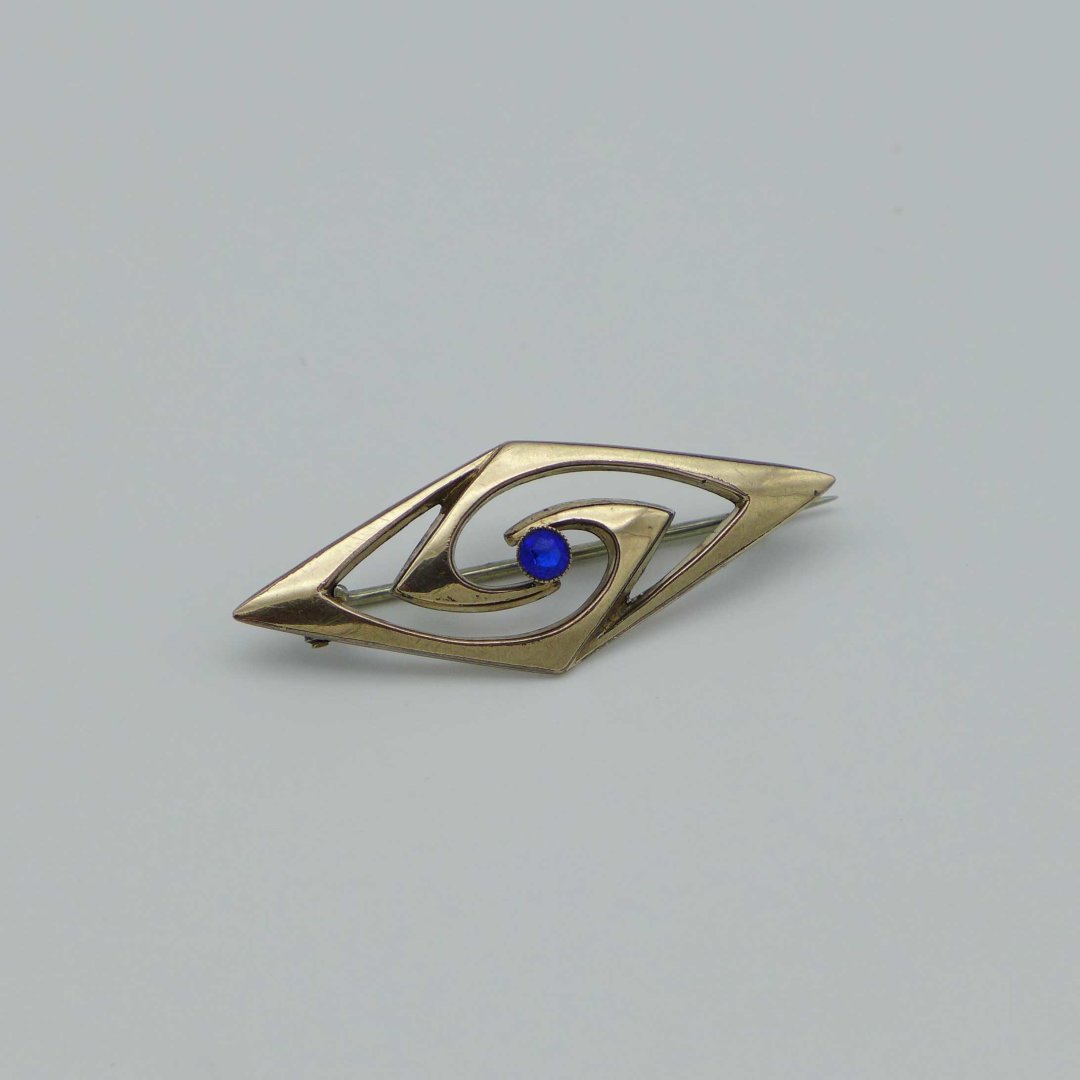 Rose gold-plated art nouveau pin with blue stone