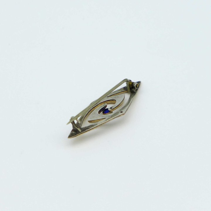 Rose gold-plated art nouveau pin with blue stone