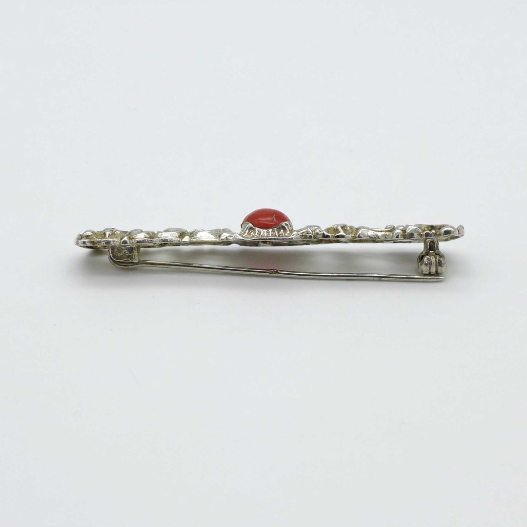 Elongated silver brooch with coral