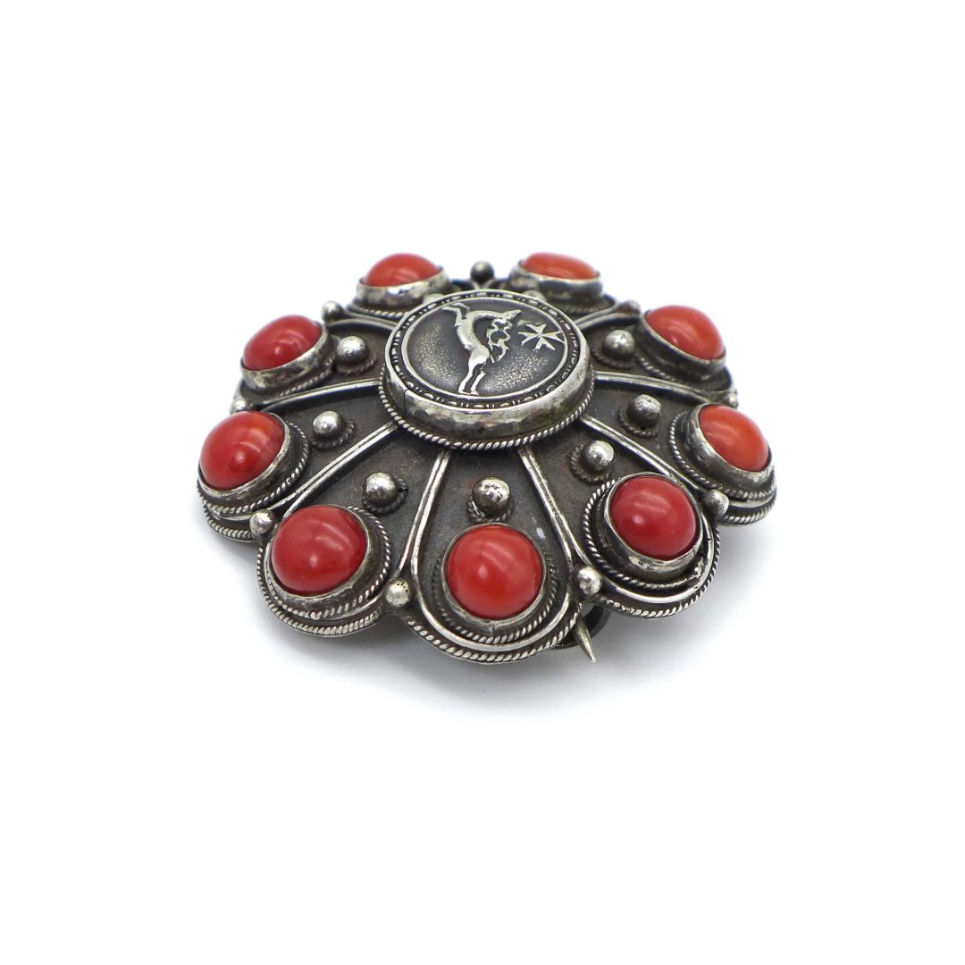 Handmade coral brooch with hunting motif