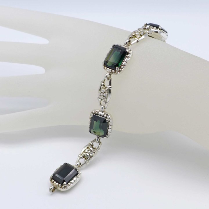 Silver bracelet with flowers and green stones