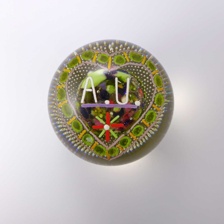 Glass paperweight with monogram A.U.