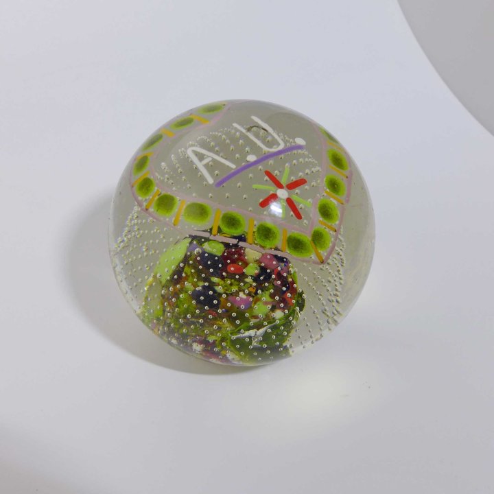 Glass paperweight with monogram A.U.