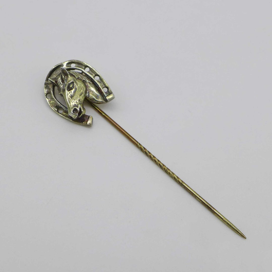 Silver pin with horseshoe and horse head