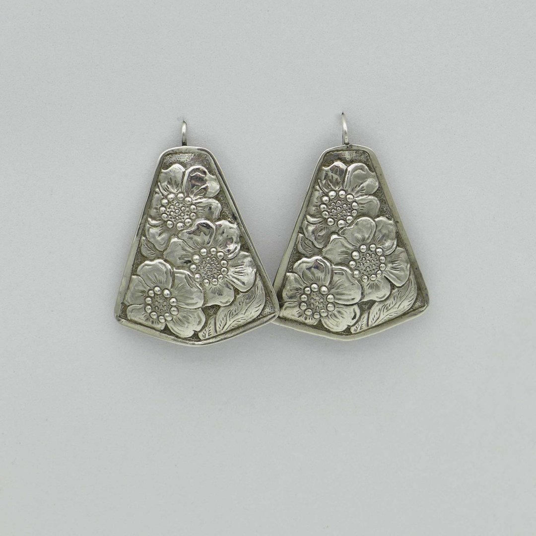 Large silver earrings with flower pattern