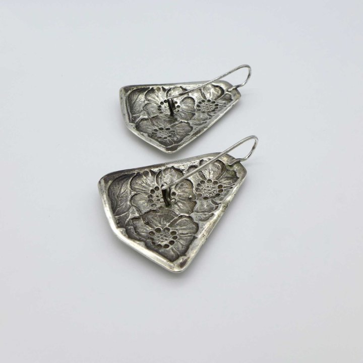 Large silver earrings with flower pattern
