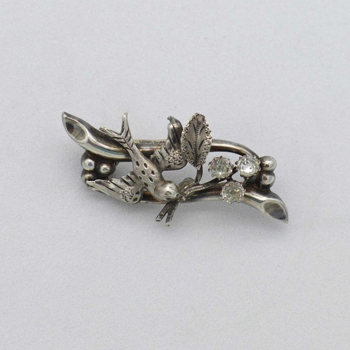 Silver brooch with swallow and rhinestone