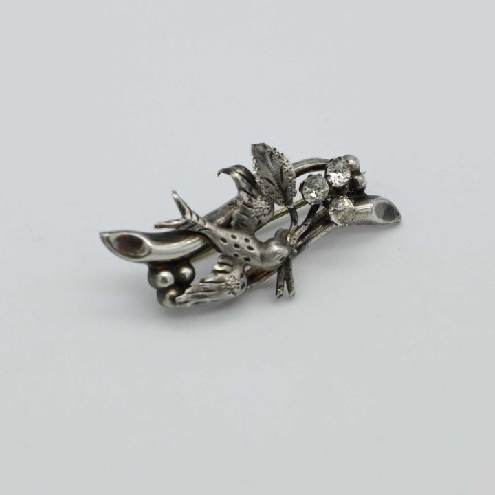 Silver brooch with swallow and rhinestone
