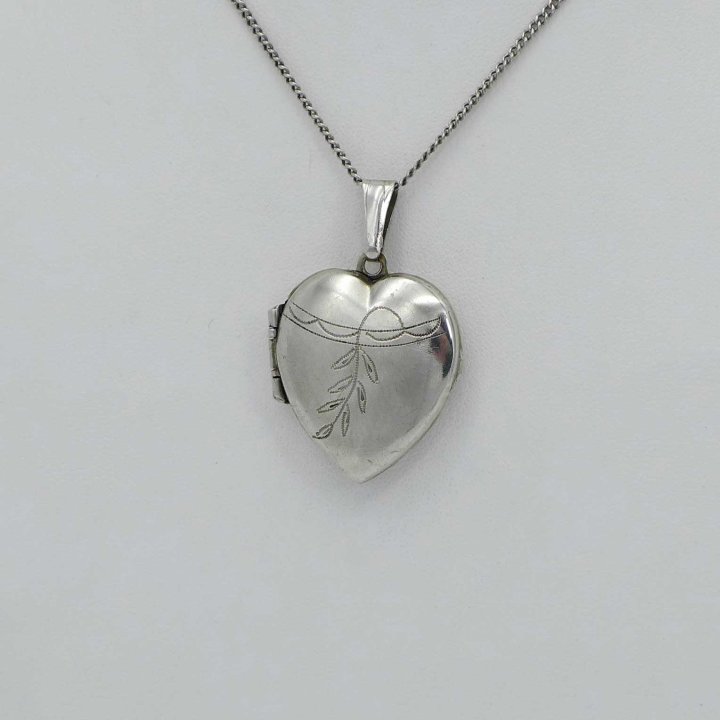 Silver medallion in the shape of a heart