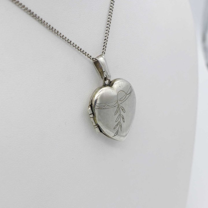 Silver medallion in the shape of a heart