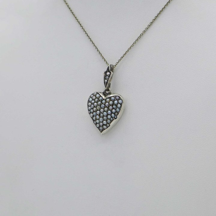 Silver amulet in the shape of a heart with oriental pearls