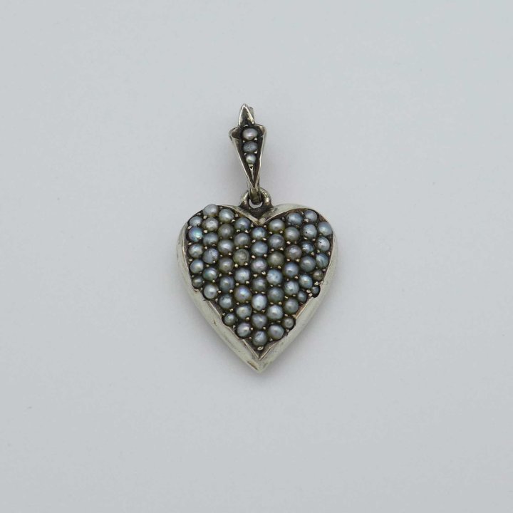 Silver amulet in the shape of a heart with oriental pearls