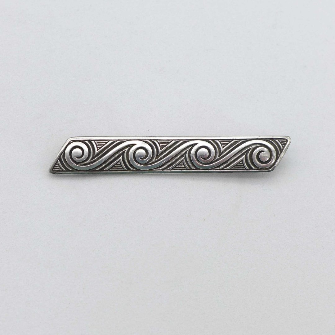 Silver pin with wave pattern