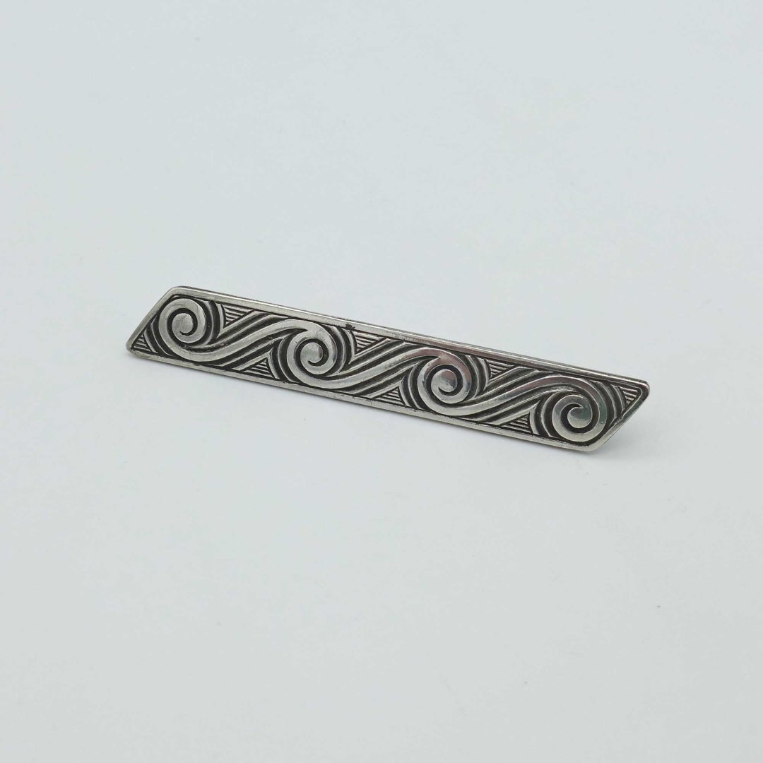 Silver pin with wave pattern