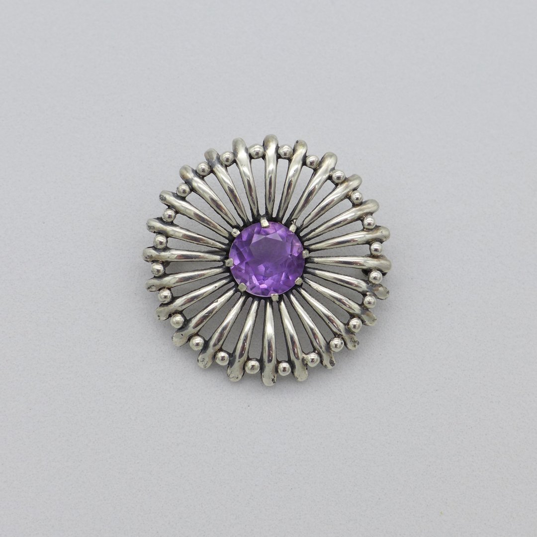 Round silver brooch with amethyst