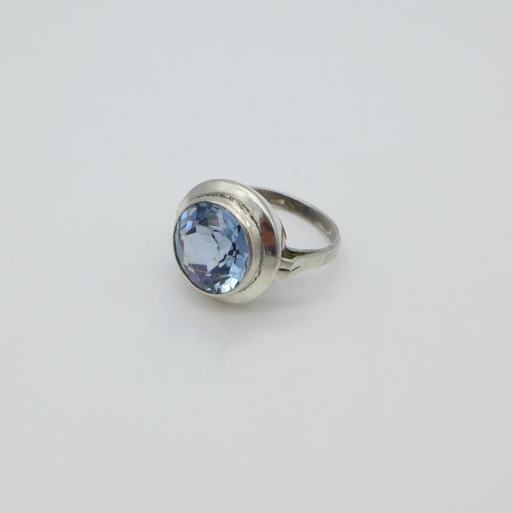 Round silver ring with light blue stone