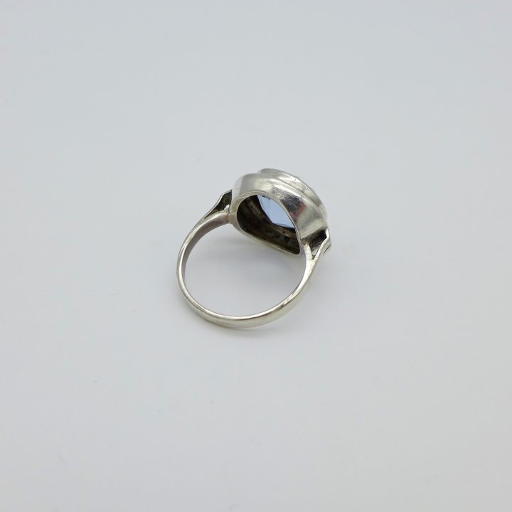 Round silver ring with light blue stone