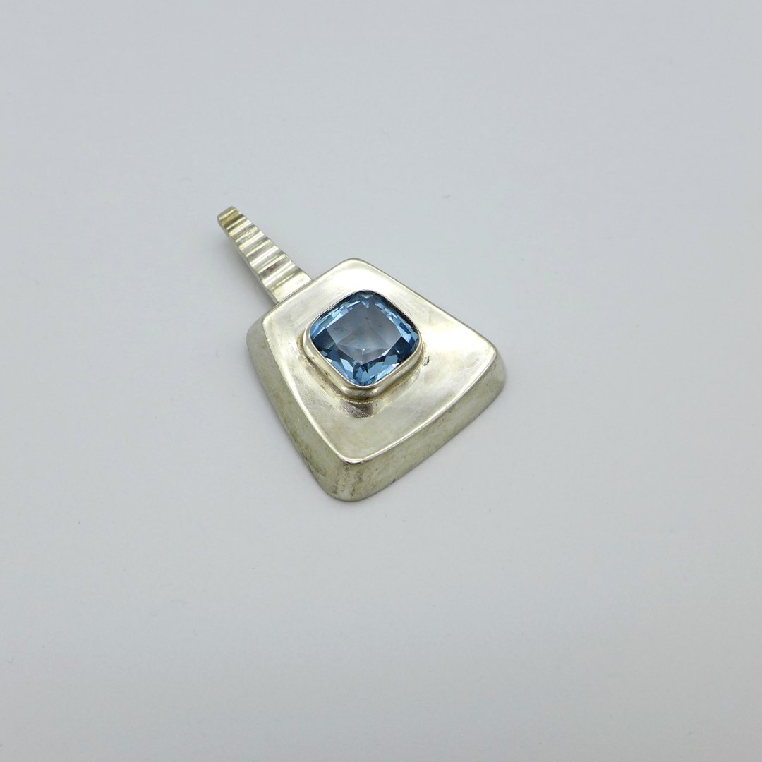 Technical pendant with light blue stone