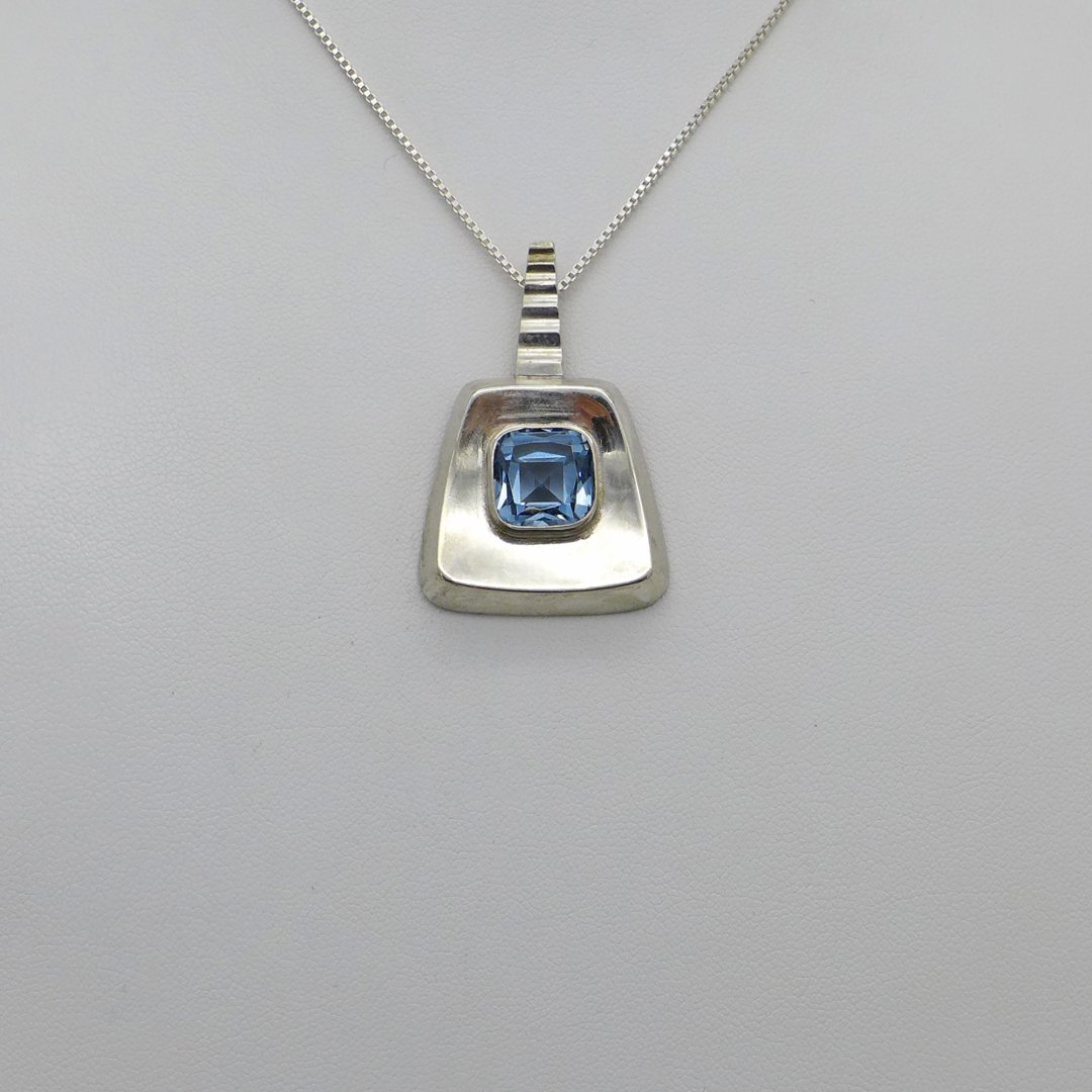 Technical pendant with light blue stone