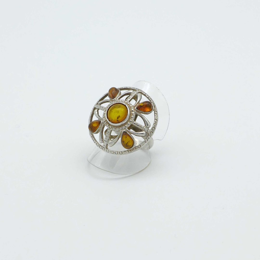 Shield-shaped silver ring with amber stones