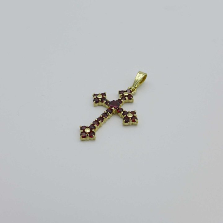 Gold cross with garnet