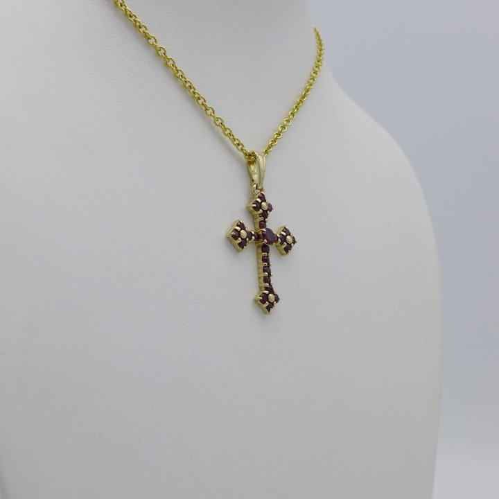 Gold cross with garnet