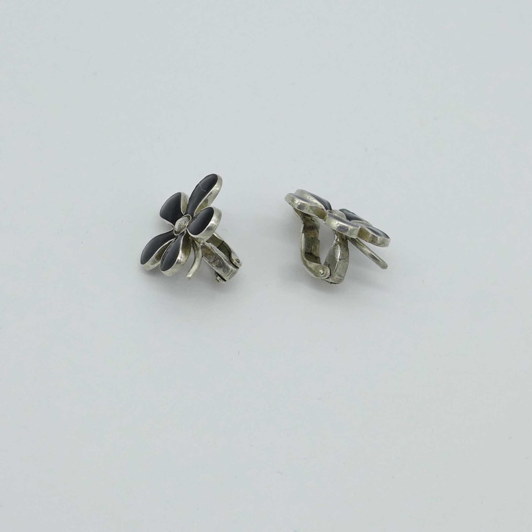 Silver earclips with black enamel flower