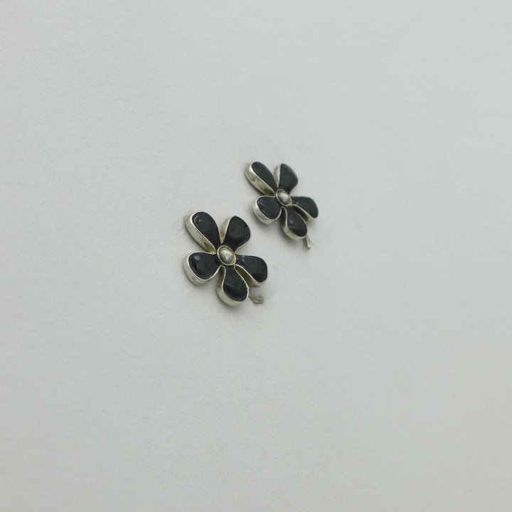 Silver earclips with black enamel flower