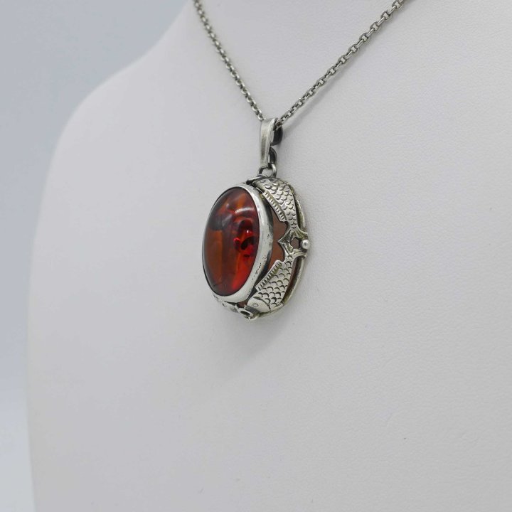 Fischland - Oval pendant with amber cabochon and fish motifs.