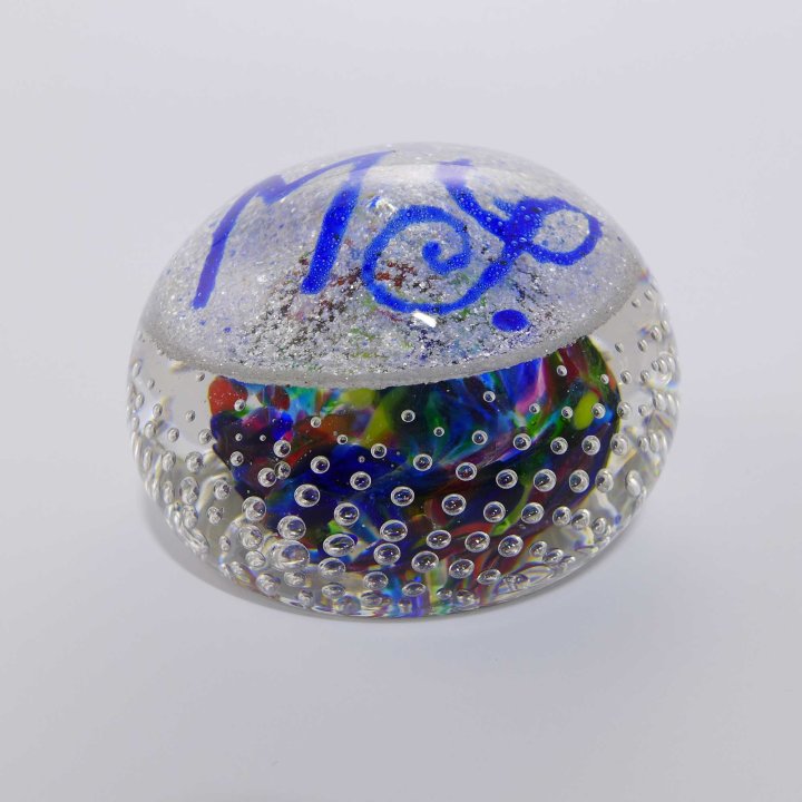 Glass paperweight with monogram MS.