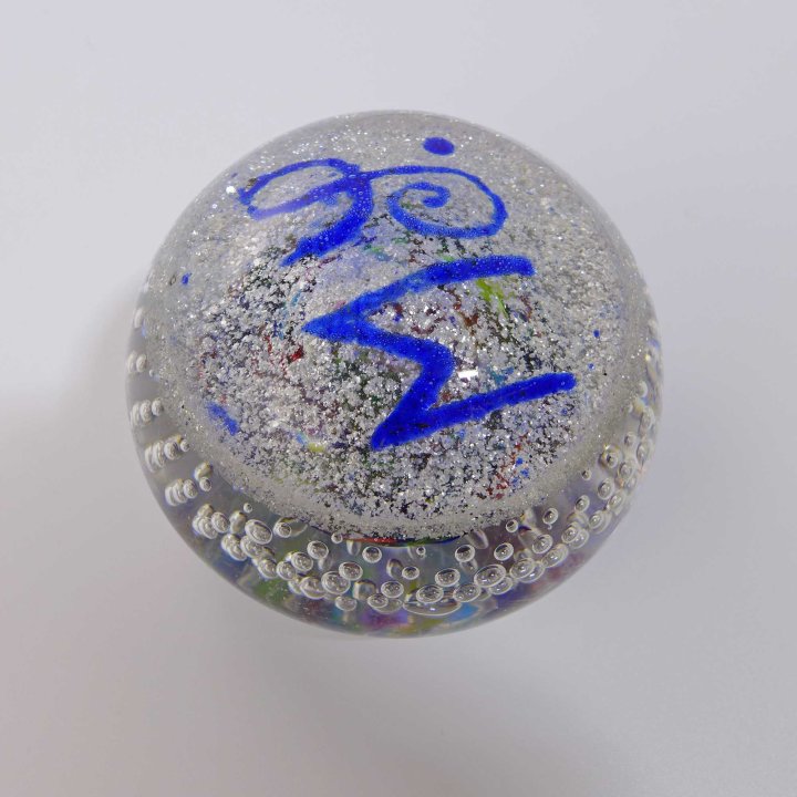 Glass paperweight with monogram MS.
