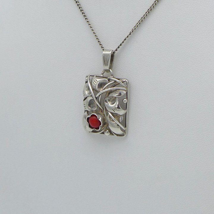Handmade pendant with tendril motif and coral