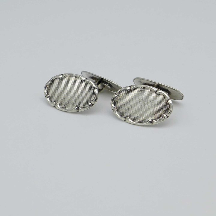Silver cufflinks with baroque decoration