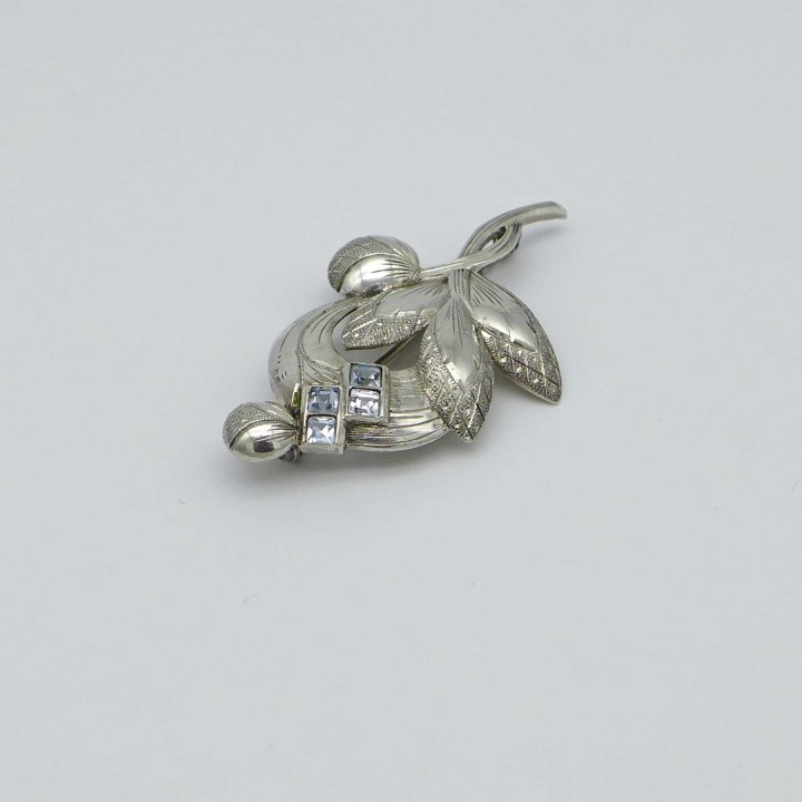 Floral silver pin with light blue stones